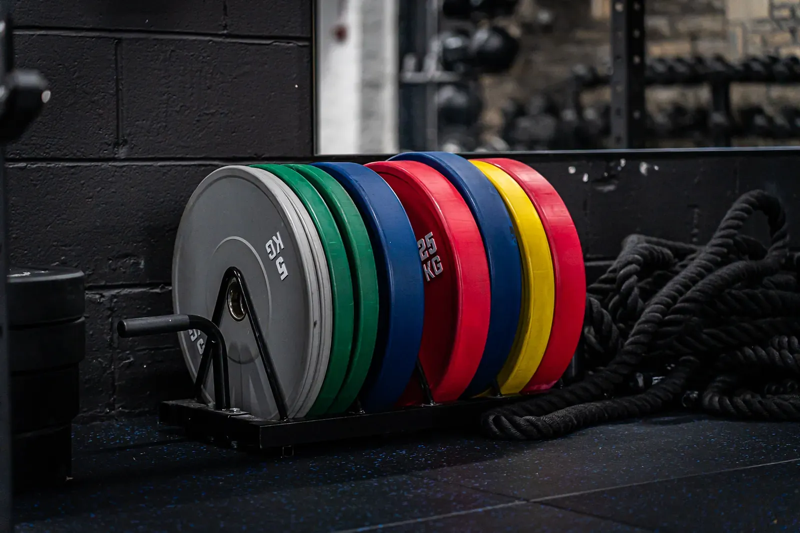 Colour-coded Olympic weight plates on the lifting platform